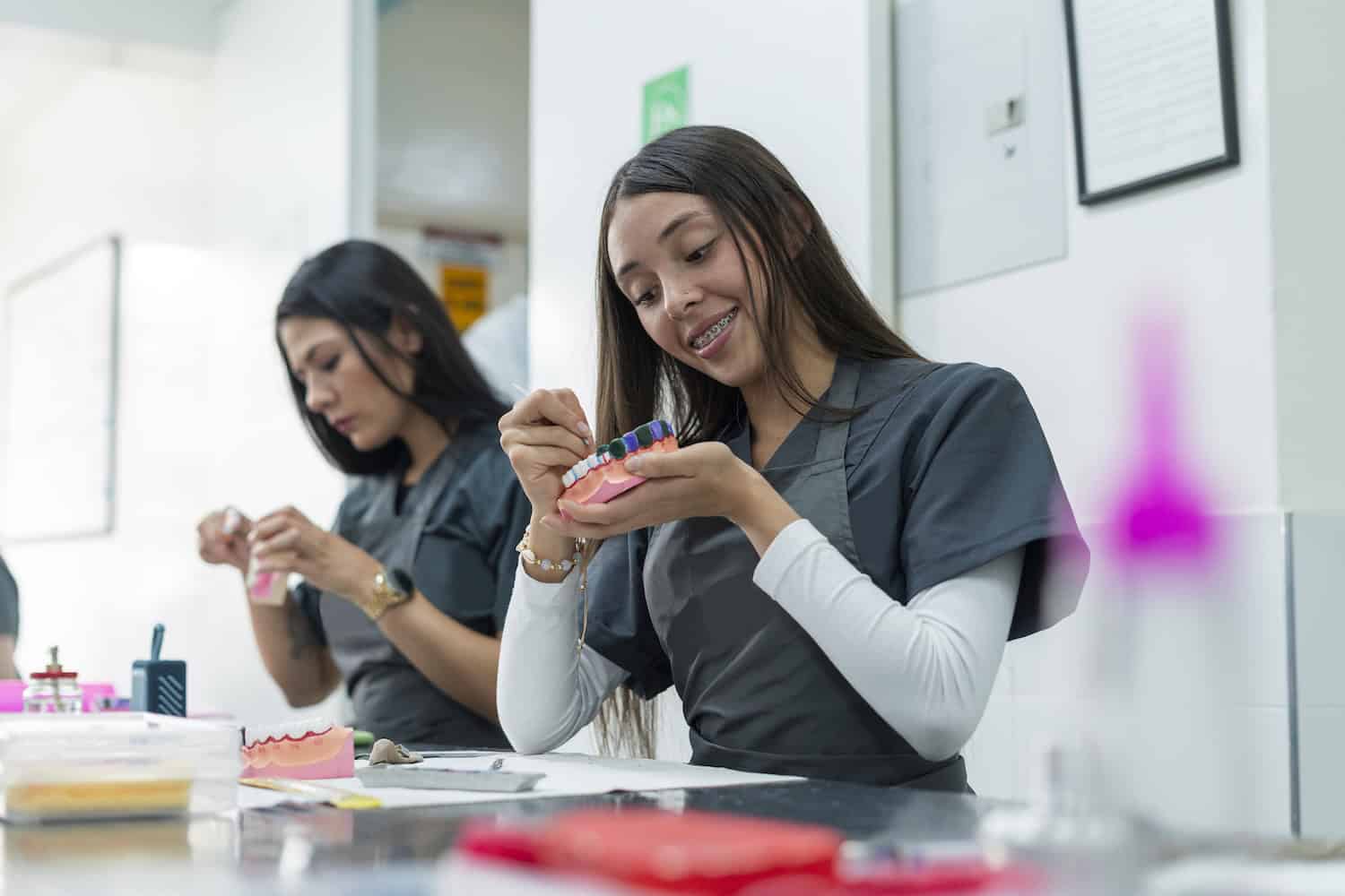 Dentistry student performs her exercises in class while working with ceramic teeth