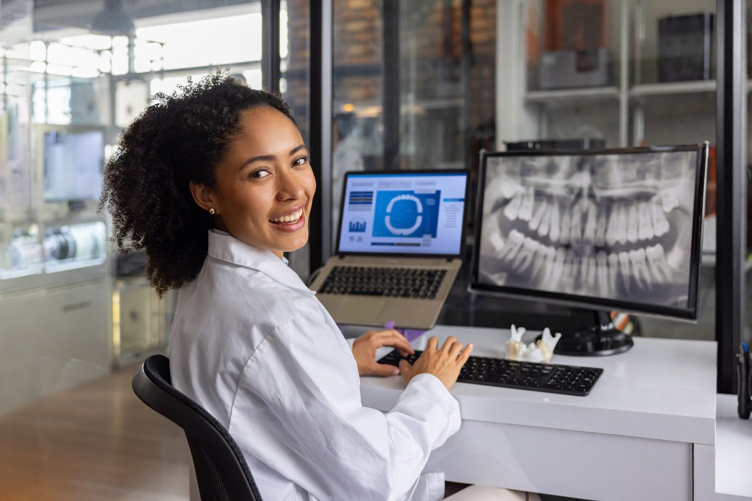 Happy healthcare worker designing a dental mold at a 3D laboratory