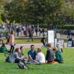 cal poly students sitting on green